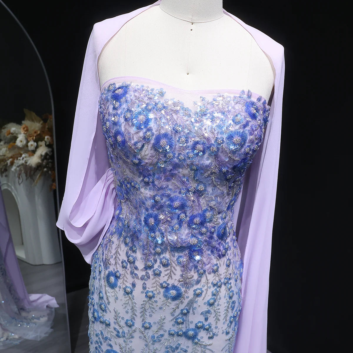 Whispering Bloom Embroidered Gown with Draped Cape and 3D Blue Florals