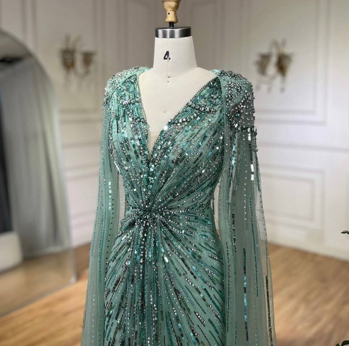 Elegant Fitted Gown with Beaded Details and Dramatic Cape