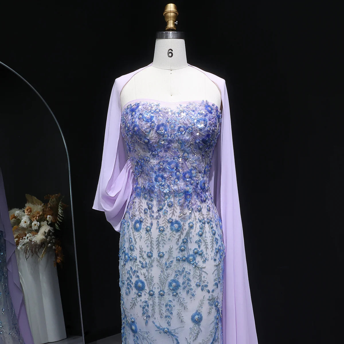 Whispering Bloom Embroidered Gown with Draped Cape and 3D Blue Florals