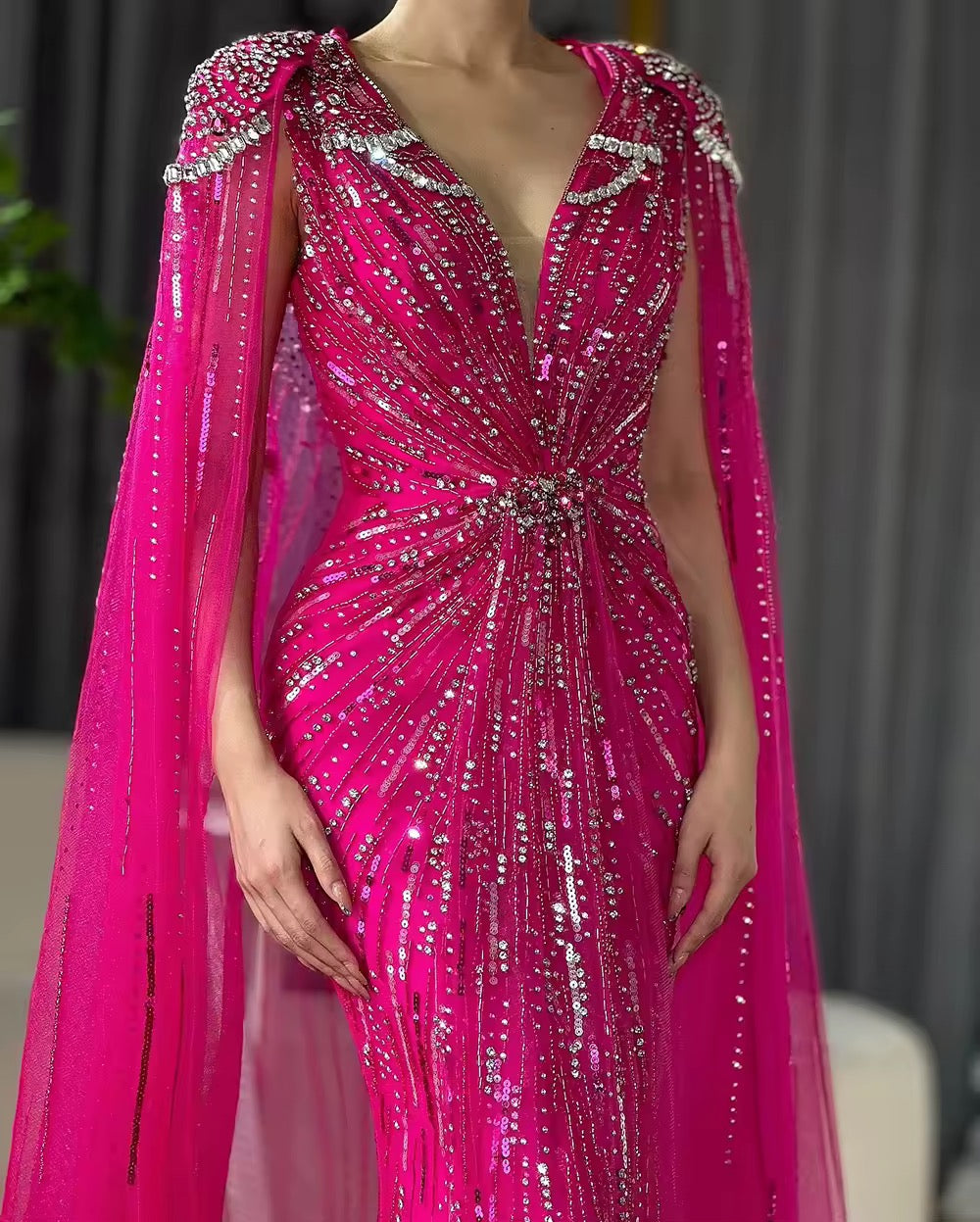 Elegant Fitted Gown with Beaded Details and Dramatic Cape