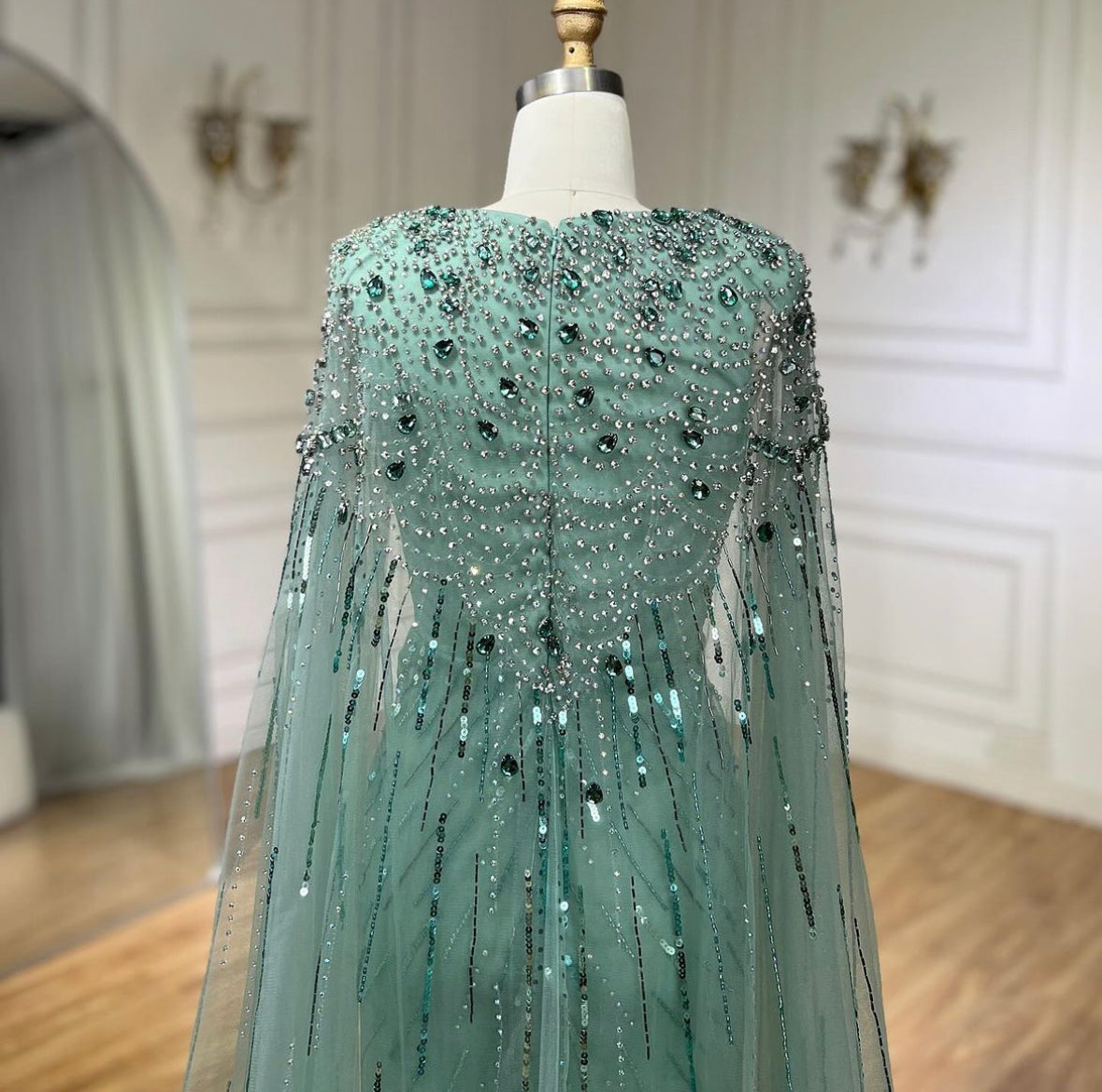 Elegant Fitted Gown with Beaded Details and Dramatic Cape