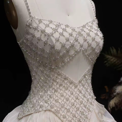Elegant Off-White Crystal Bodice Gown with Voluminous Tulle Waves