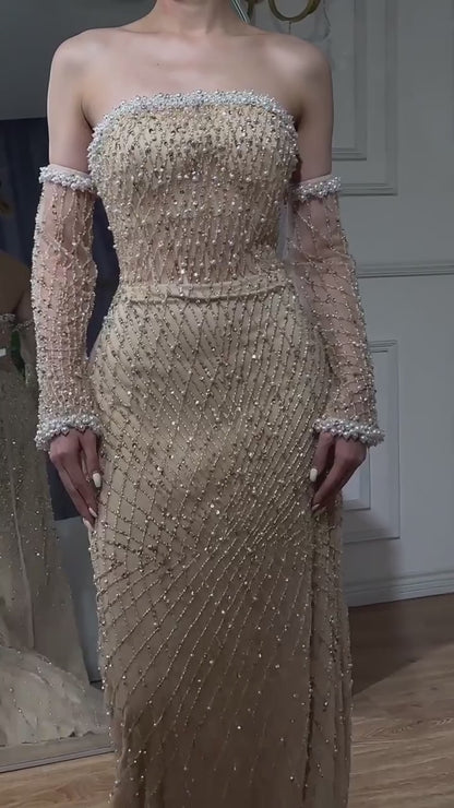 Dress with a pearl-decorated sleeve